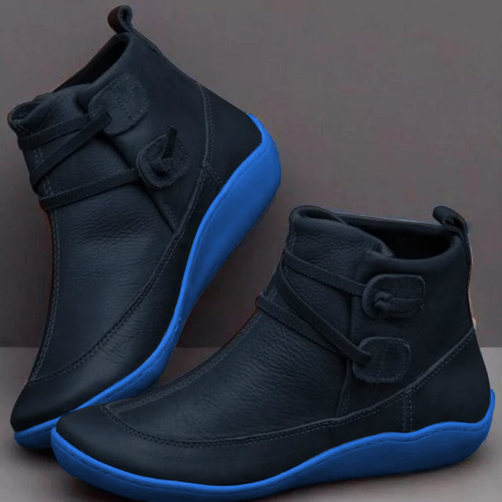 Black side lace ankle boots with a blue sole edge
