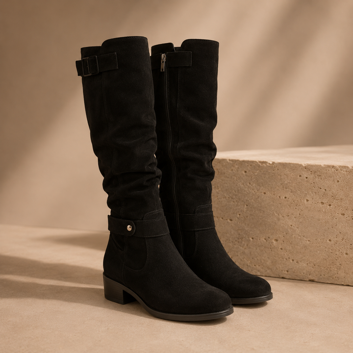 Black suede knee high boots with a slouched shaft