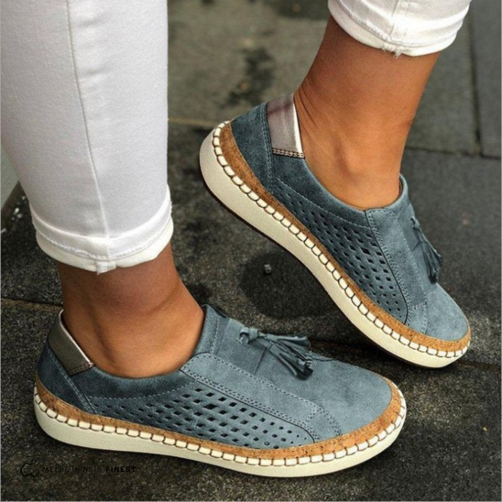 Blue slip on sneakers with perforated panels and a tassel