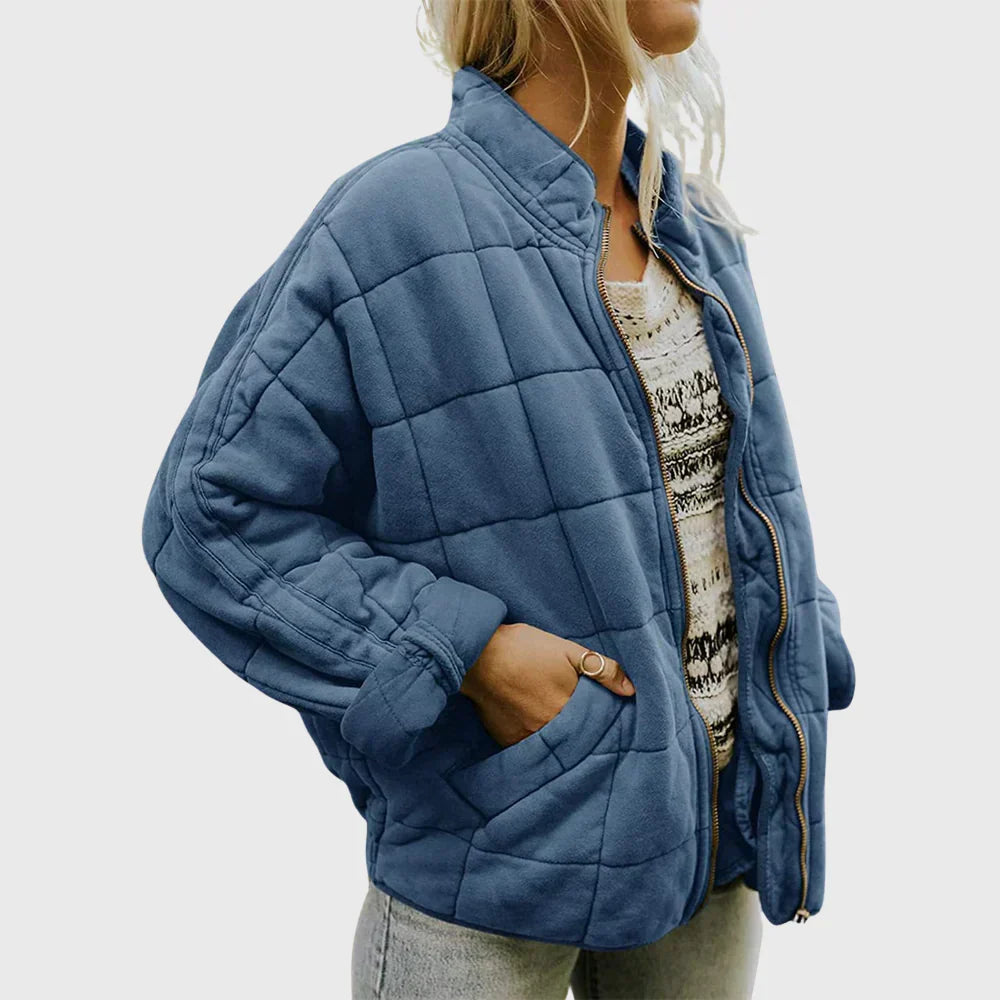 Denim blue box quilted bomber jacket with gathered cuffs, front view