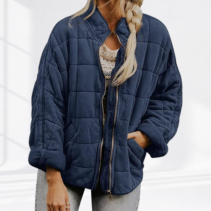 Navy box quilted bomber jacket worn open, three quarter view