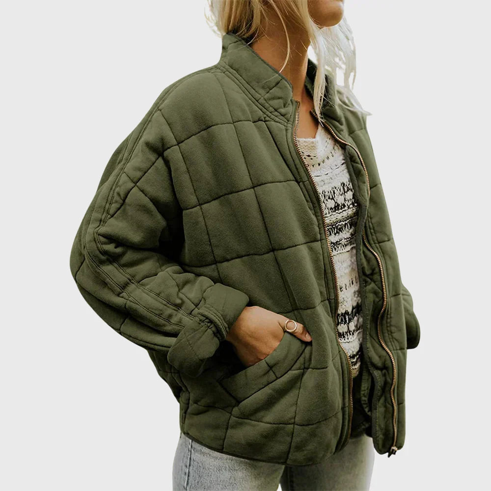 Olive box quilted bomber jacket worn open over a knit top, front view