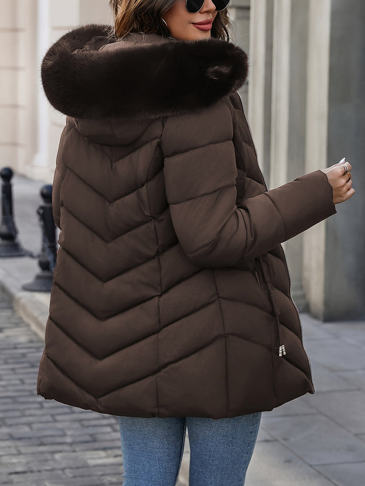 Brown quilted coat seen from the side with the fur hood up