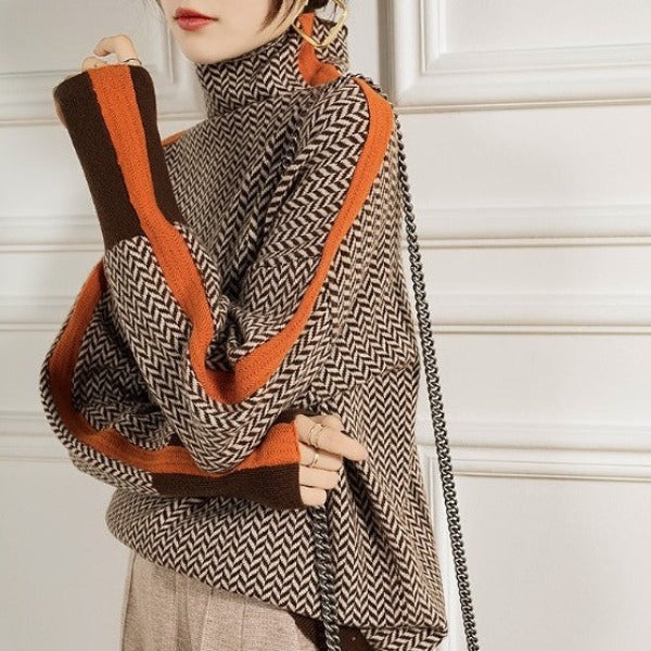 Brown herringbone turtleneck sweater with orange trim and contrast cuffs, front view