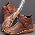 Brown side lace ankle boots with water splashing across them