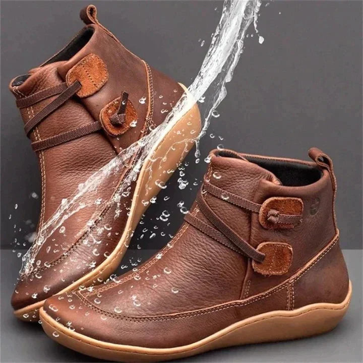 Brown side lace ankle boots with water splashing across them