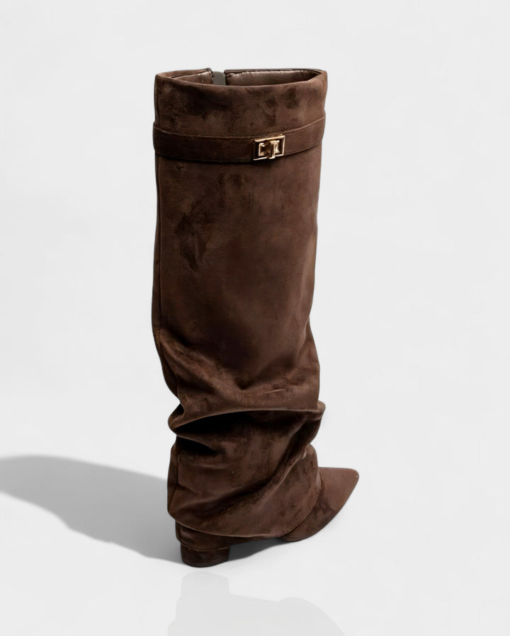 Close view of the strap and turn lock on the brown suede boot