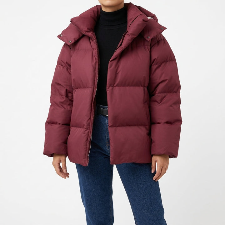 Burgundy oversized puffer coat worn open over jeans, front view