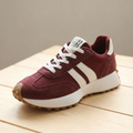 Burgundy suede sneaker with cream side stripes and gum sole, angled view