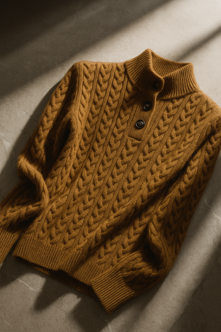 Caramel cable knit sweater with a stand collar, shown flat at an angle in daylight