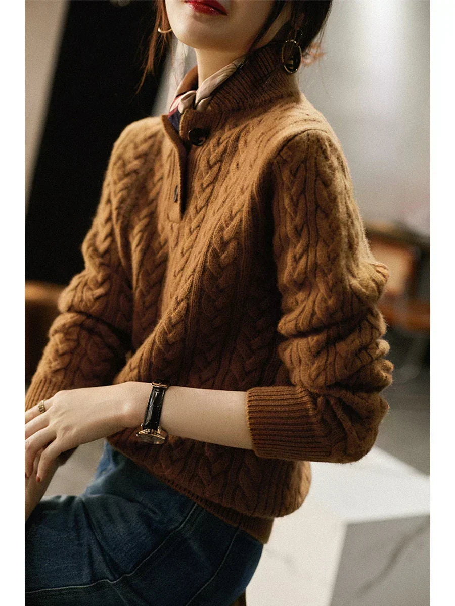 Caramel cable knit sweater with a stand collar, worn at a side angle indoors