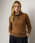 Caramel cable knit sweater with a stand collar, worn with dark pants, full front view