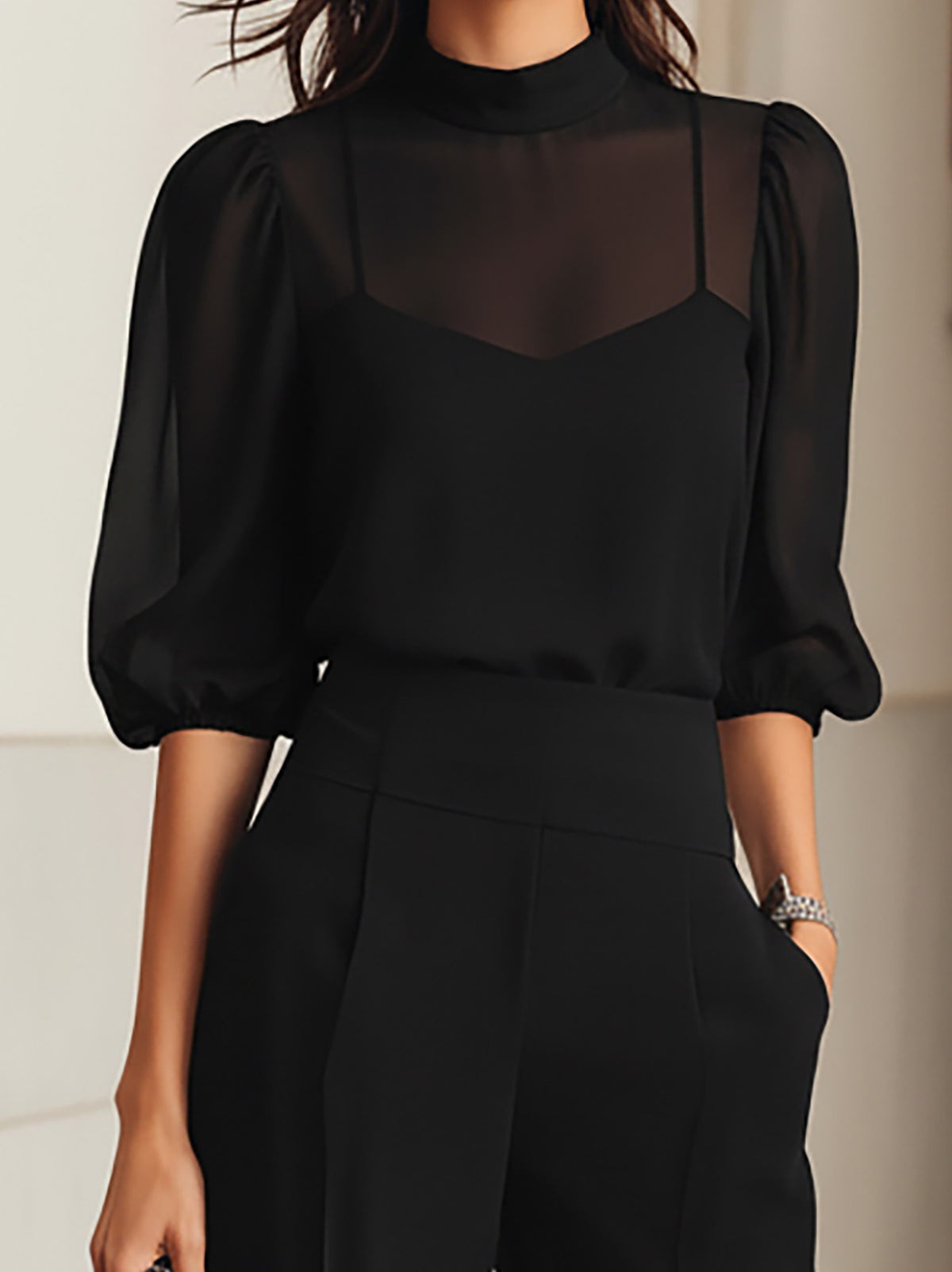 Close-up of the sheer puff sleeves and camisole of the black set