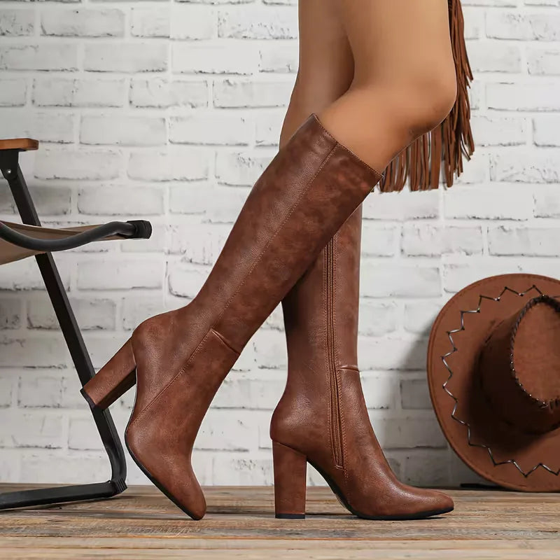 Brown knee high boots with a block heel, side view