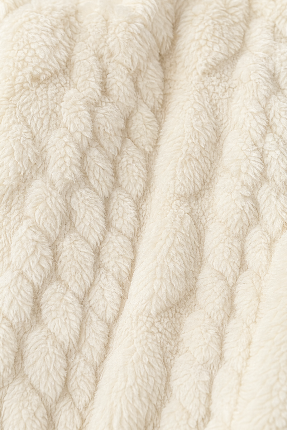 Close up of the cream cable textured fleece