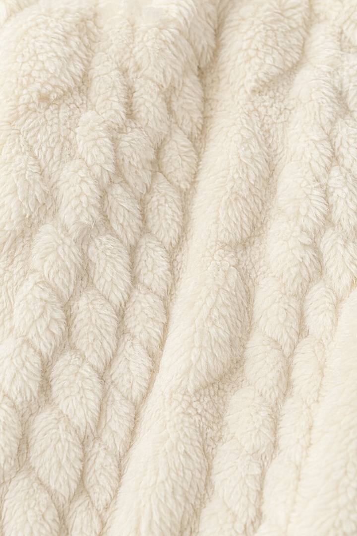 Close up of the cream cable textured fleece
