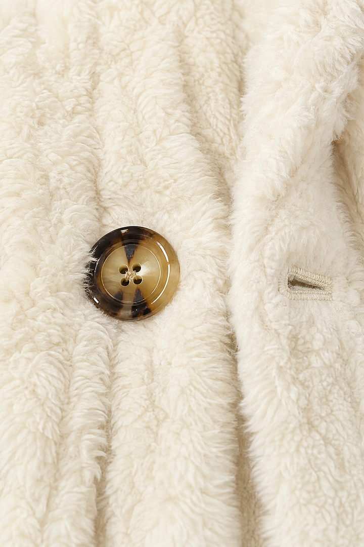 Tortoiseshell button and buttonhole on a cream fleece coat