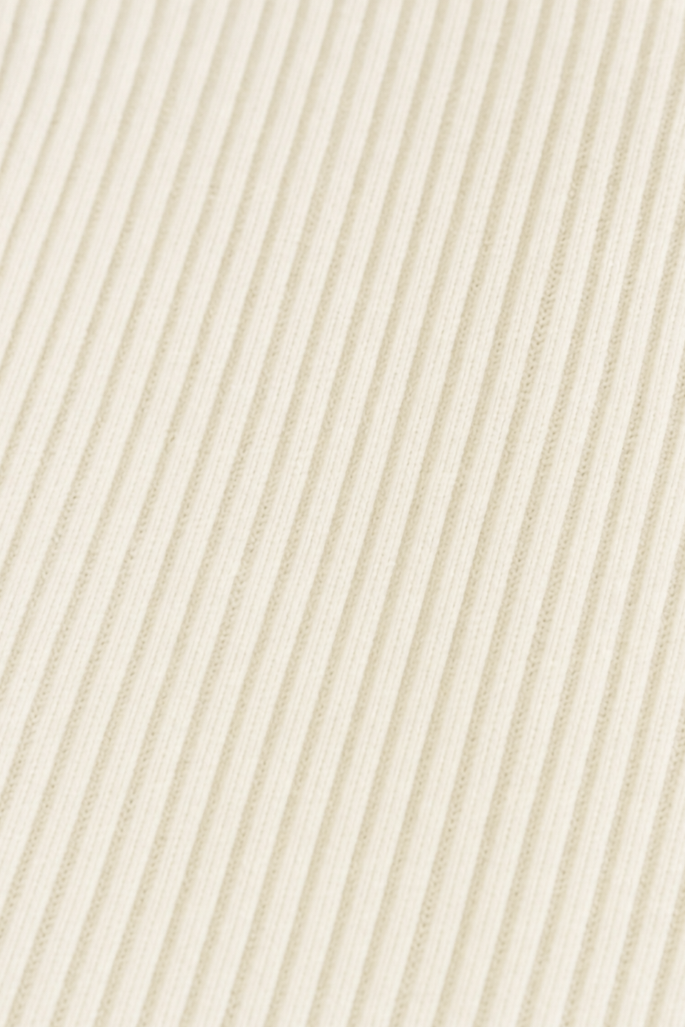 Ribbed knit texture on a cream longline coat