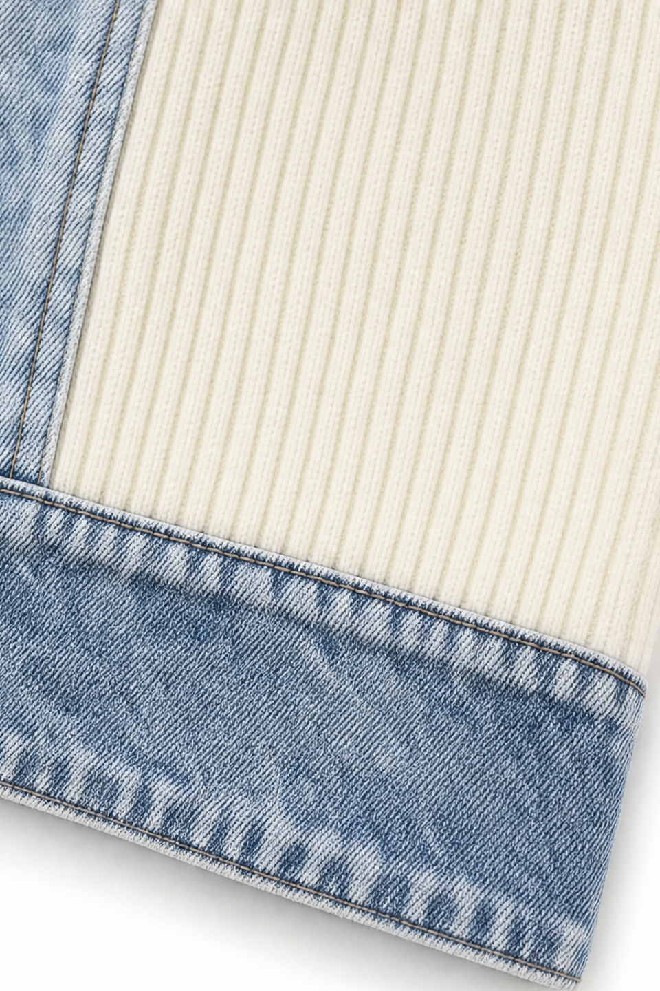 Denim hem trim on a cream ribbed knit coat