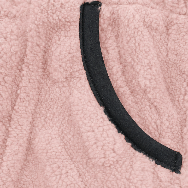 Black bound pocket edge on a pink plush fleece pullover