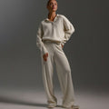 Cream knit lounge set with a collared sweater and wide leg trousers, full length view
