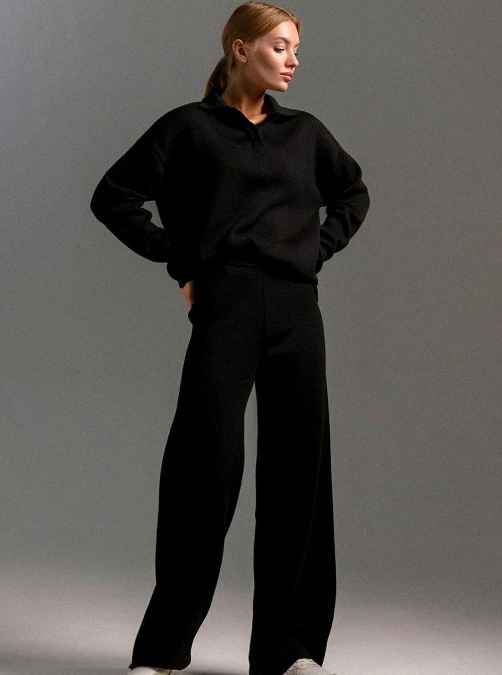 Black knit lounge set with a collared pullover and wide leg trousers, full length view