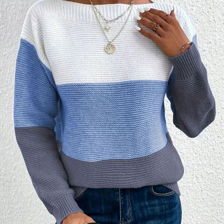 Color block knit sweater in white, blue and grey, worn with blue jeans