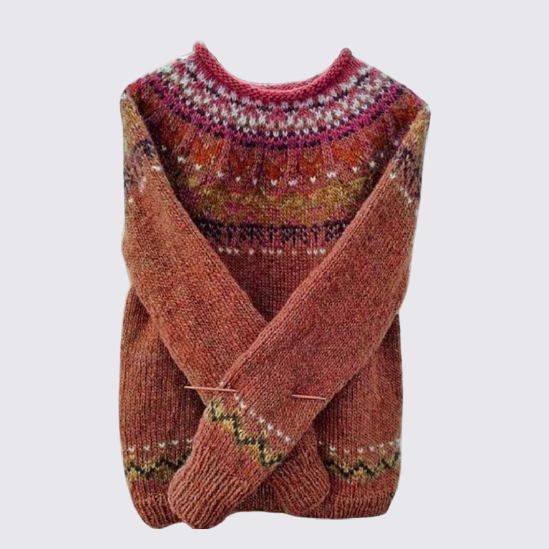 Rust fair isle sweater with patterned yoke and cuffs, folded flat
