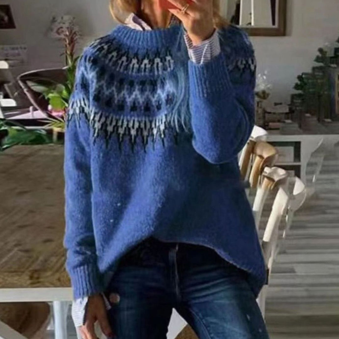 Blue knit sweater with a cream and navy Nordic pattern yoke, worn with jeans