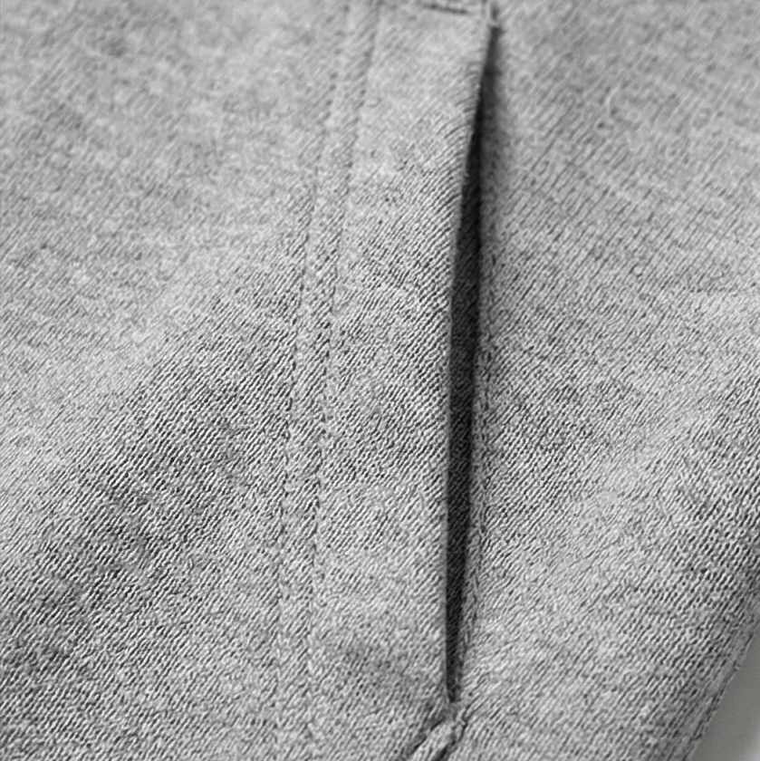 Close-up of the grey marl jersey fabric and side pocket seam