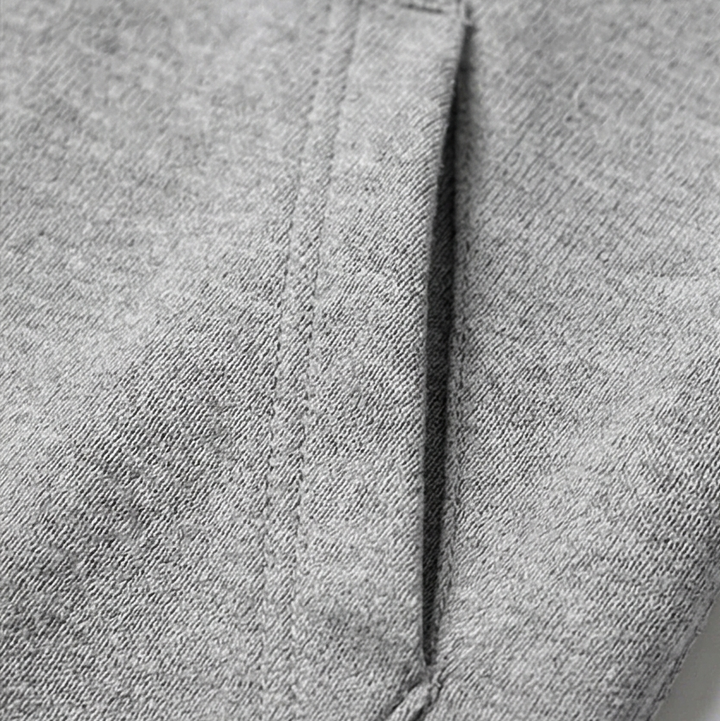 Close-up of the grey marl jersey fabric and side pocket seam