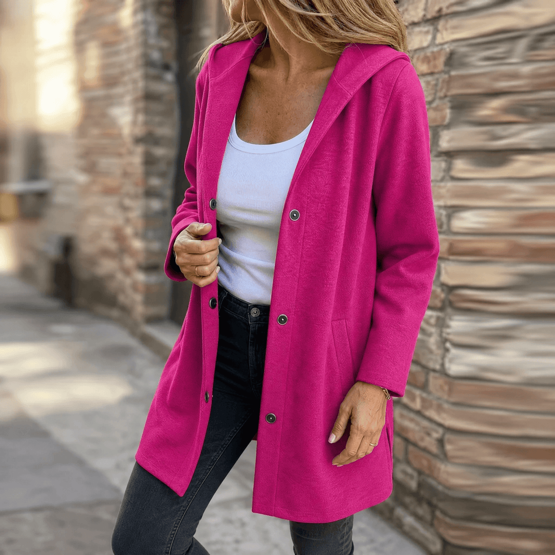 Fuchsia pink hooded longline cardigan jacket with button front, worn open outdoors