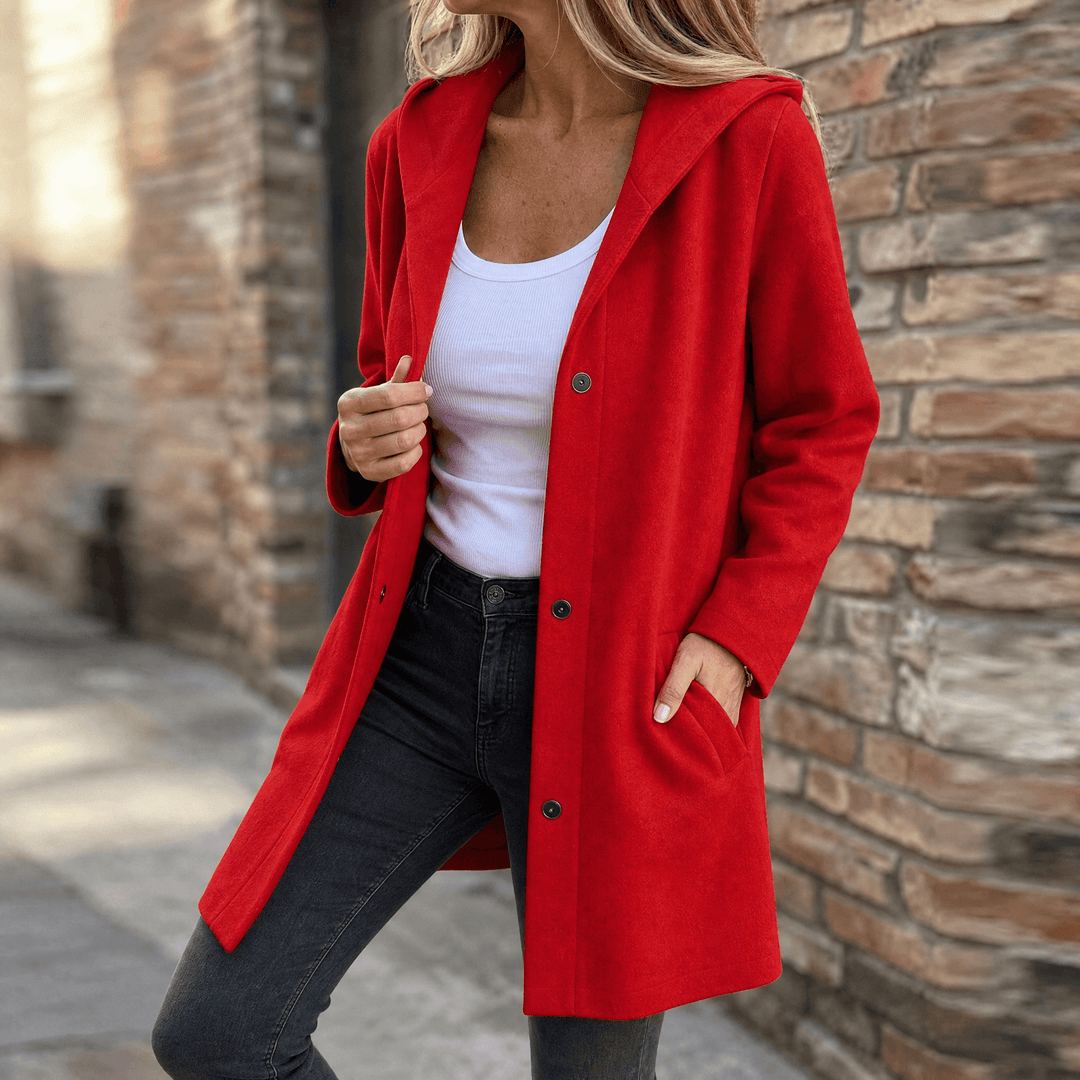 Red hooded longline cardigan jacket with button front and pockets, worn open outdoors
