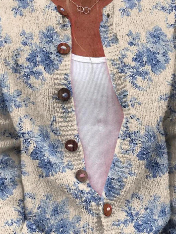 Close up of the wooden button placket on a cream cardigan with a blue floral print