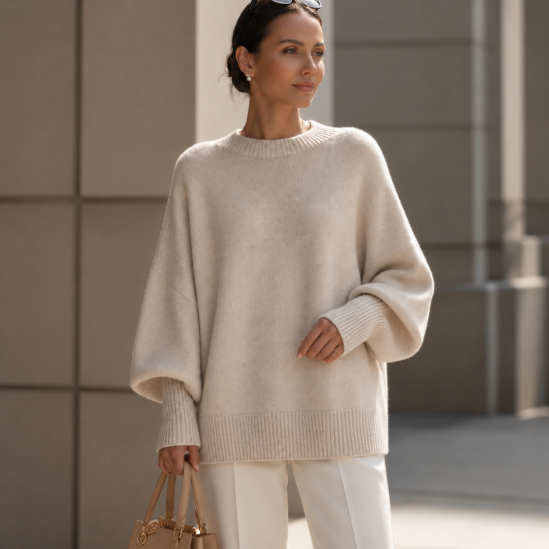 Woman outdoors in a cream oversized wool blend sweater with dropped shoulders