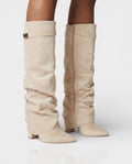 Cream suede foldover knee boots worn with bare legs, front angle