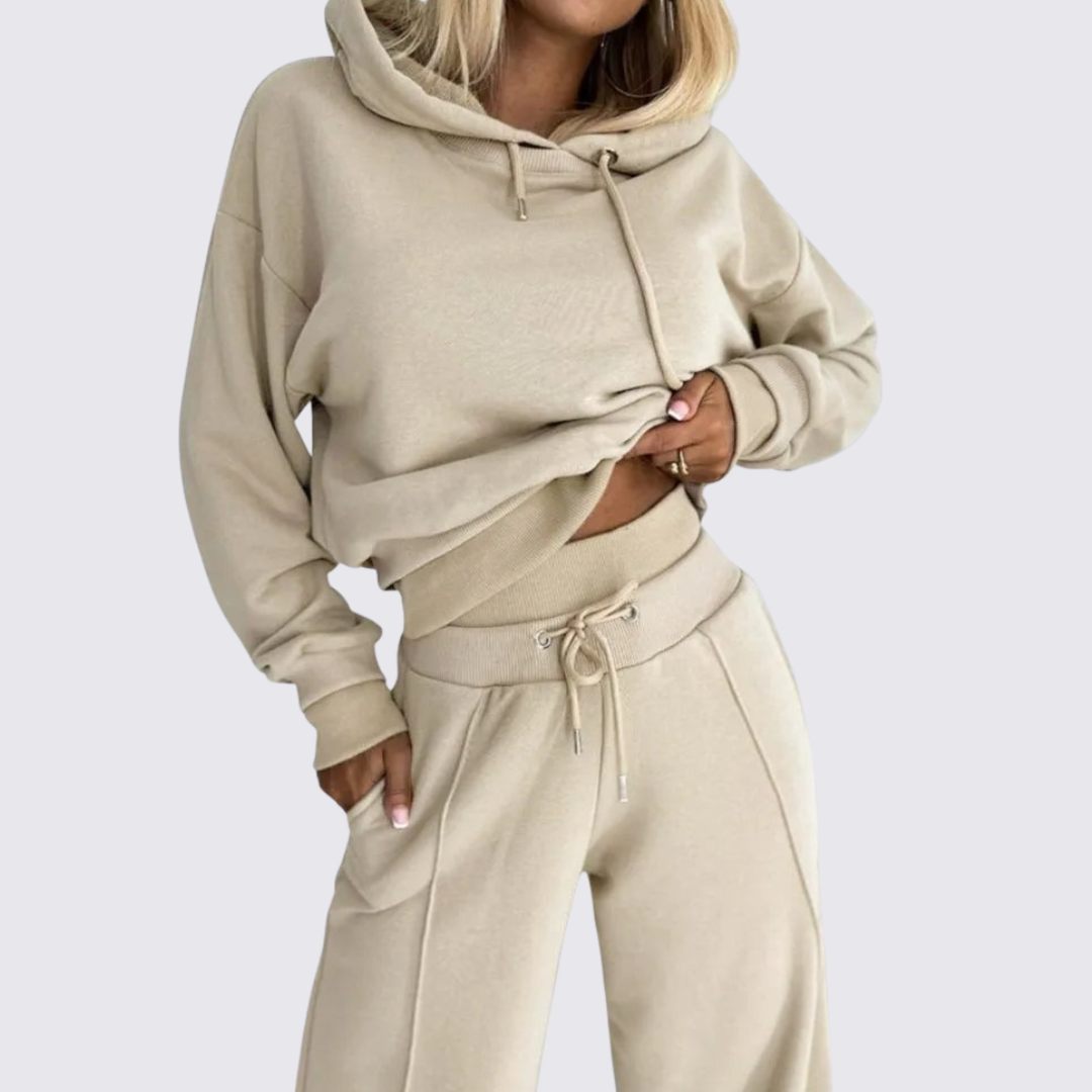 Woman wearing a beige cropped hoodie with matching wide leg drawstring pants