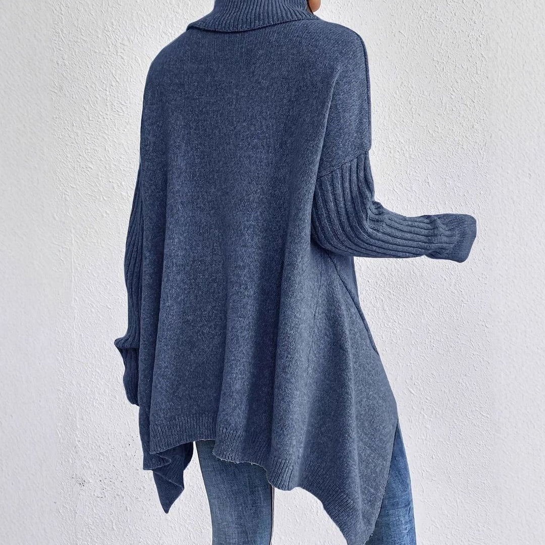 Blue oversized longline turtleneck sweater seen from the back, with a draped hem