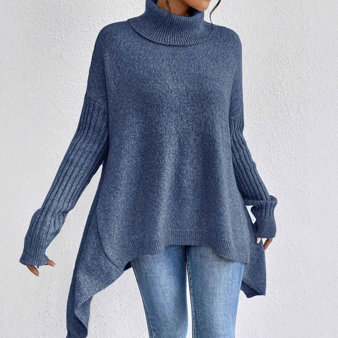 Blue oversized turtleneck sweater with an asymmetric longline hem and ribbed sleeves