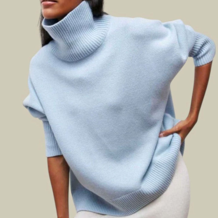 Light blue oversized turtleneck sweater with ribbed roll neck and cuffs, close front view