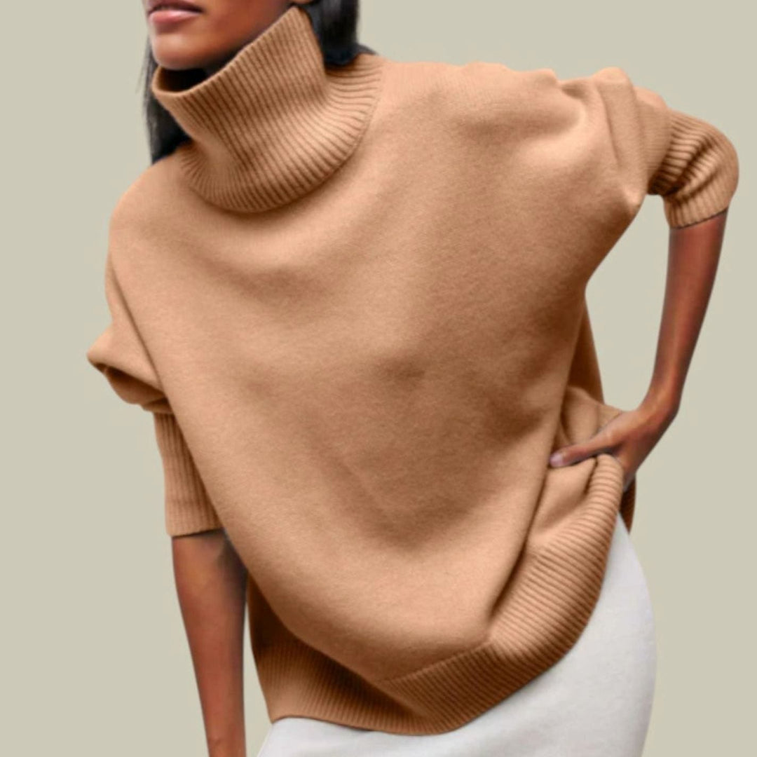 Camel oversized drop shoulder turtleneck sweater worn with a white skirt