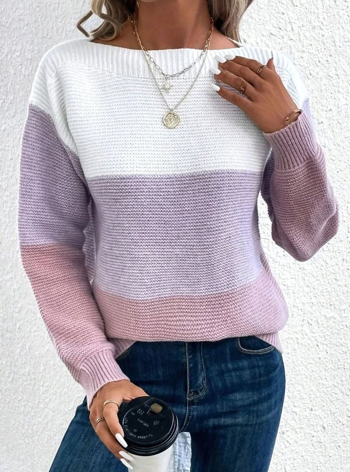 Color block knit sweater in white, lilac and pink, worn with blue jeans