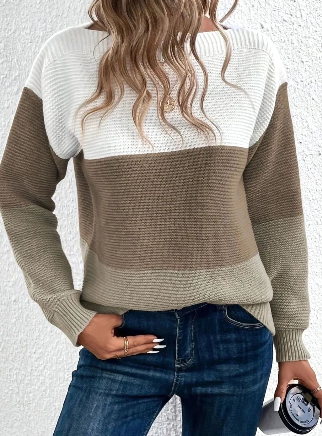 Color block knit sweater in white, brown and taupe, worn with jeans
