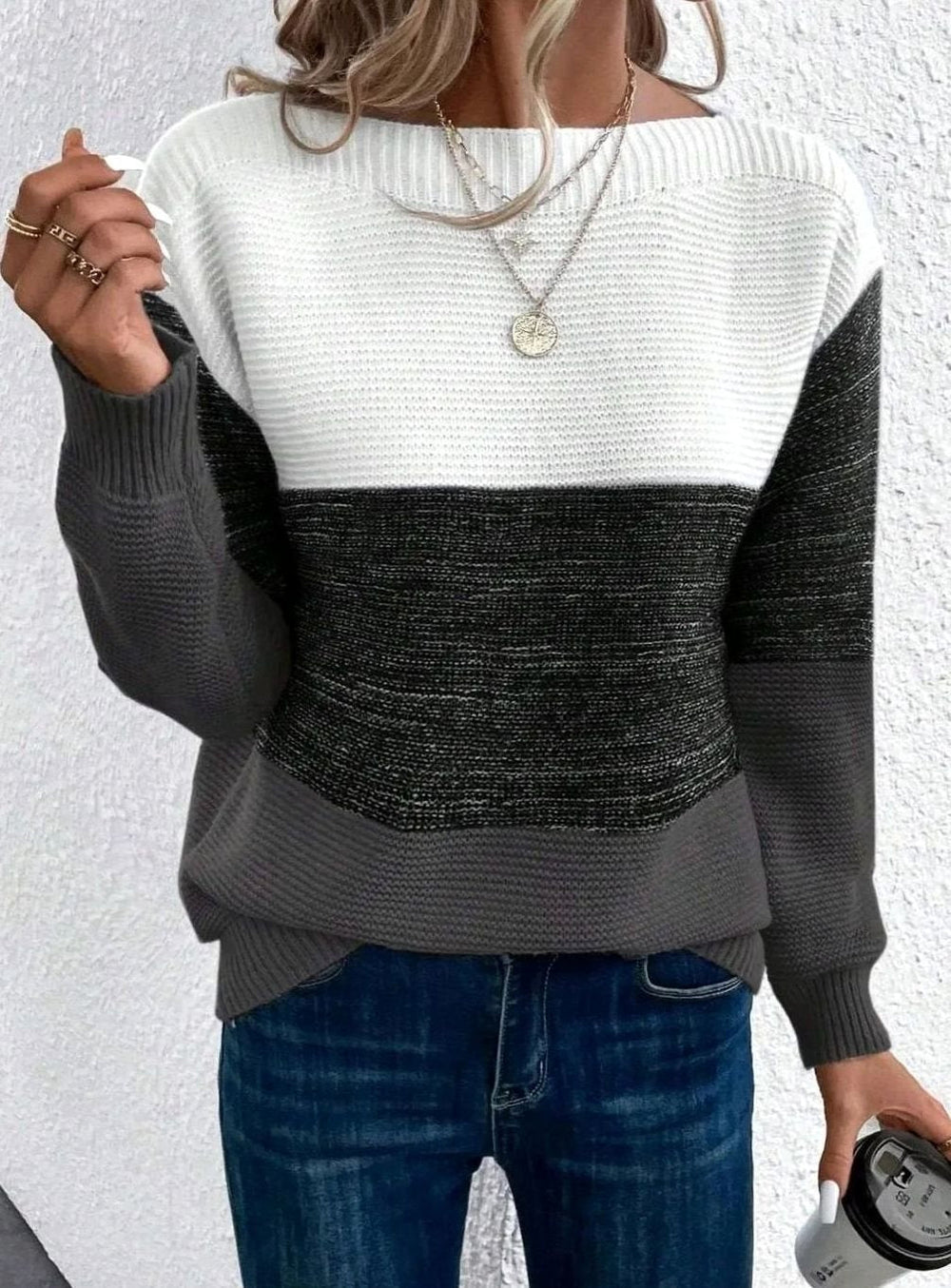 Ribbed knit sweater with white, charcoal and grey colour block panels and a boat neckline, close up