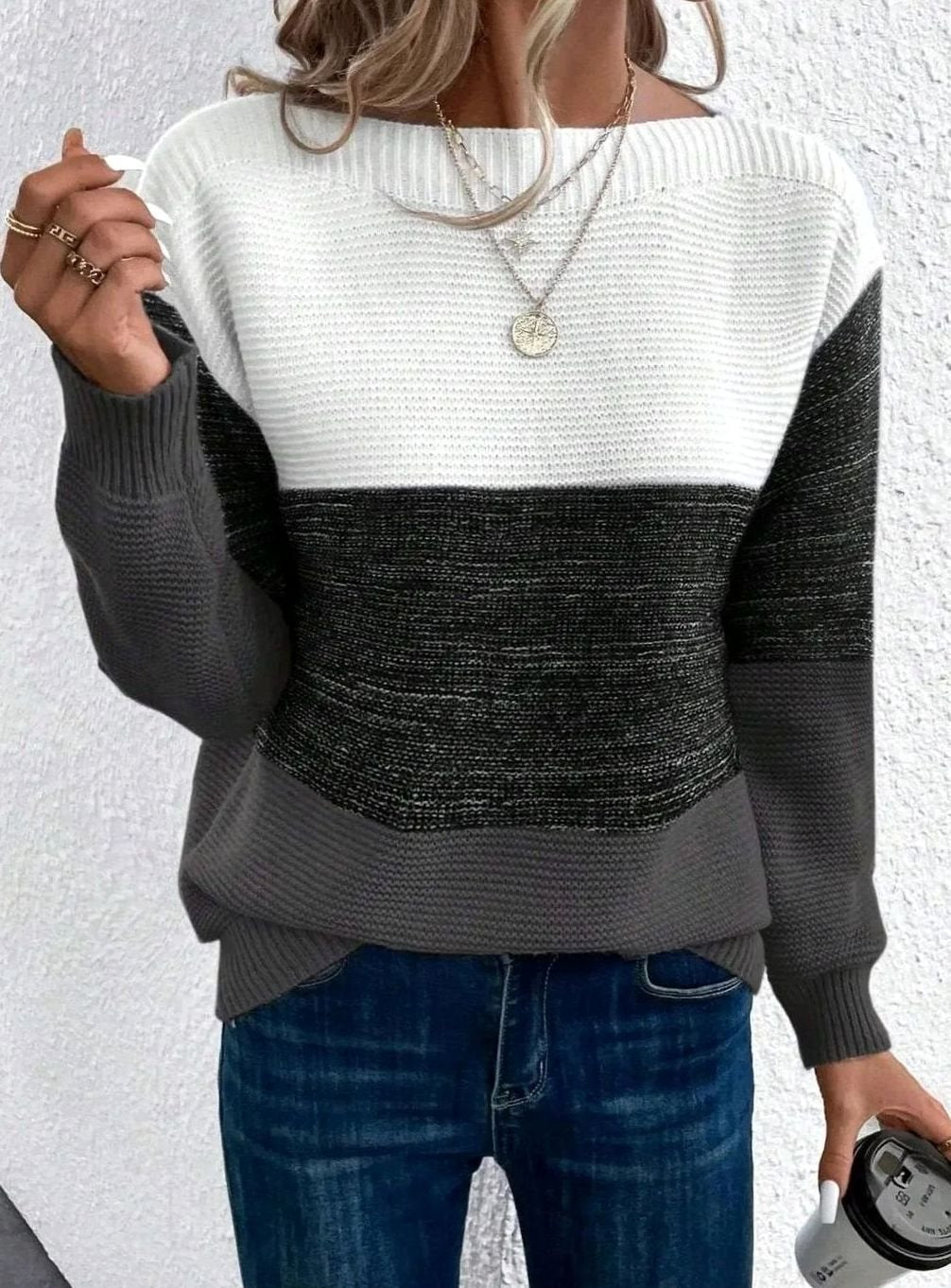 Ribbed knit sweater with white, charcoal and grey colour block panels and a boat neckline, close up
