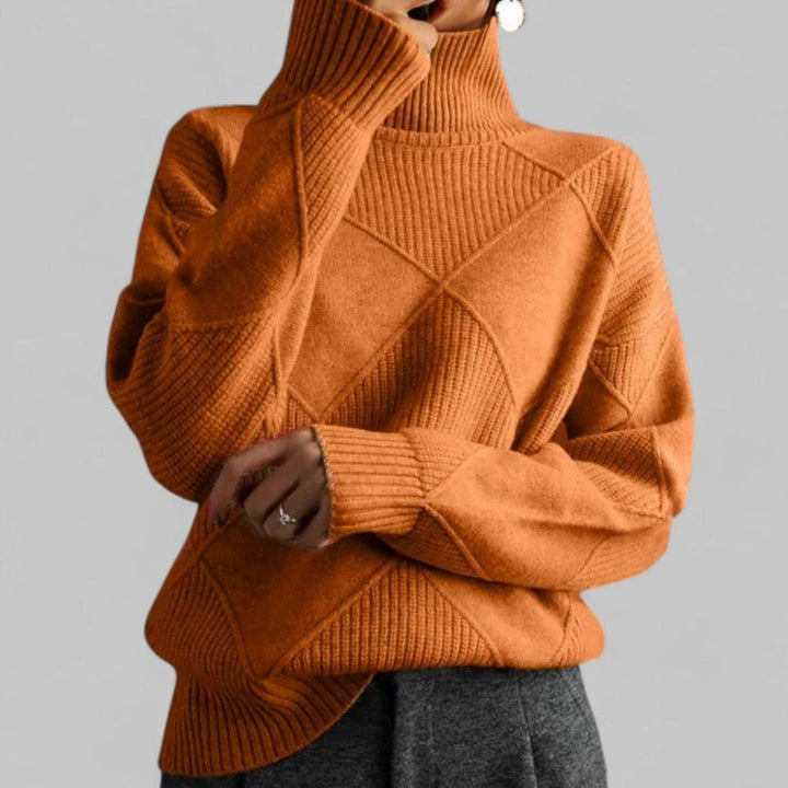 Rust orange oversized turtleneck sweater with diamond knit texture, front view