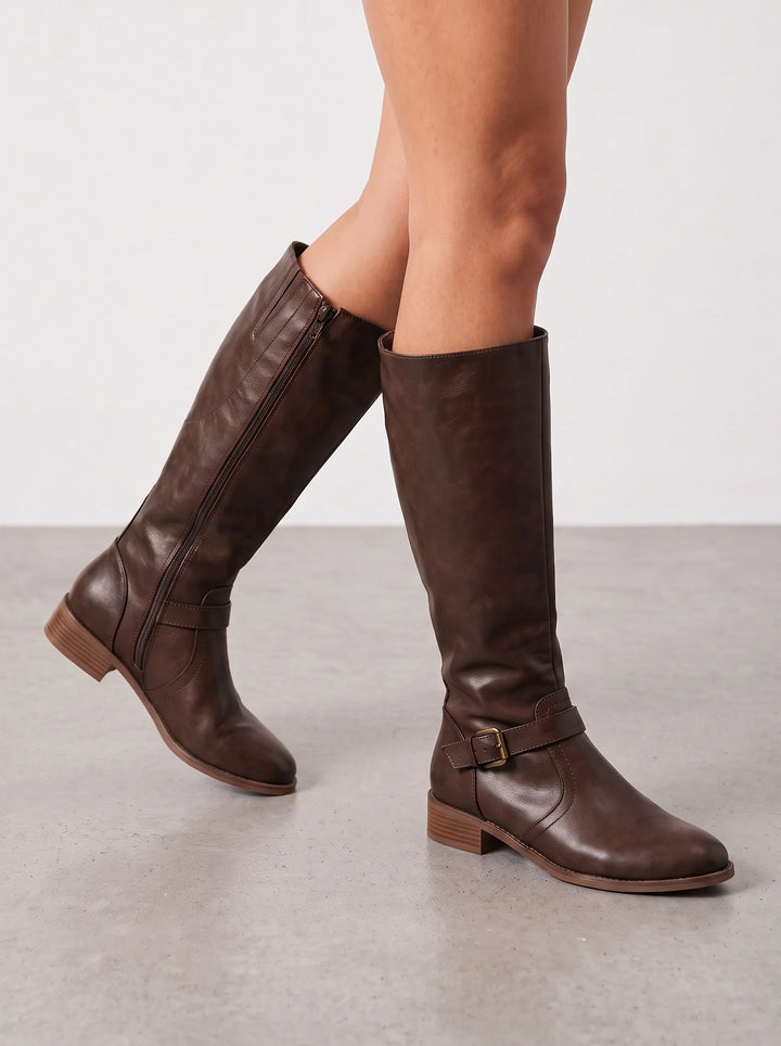 Dark brown leather riding boots with a buckled ankle strap