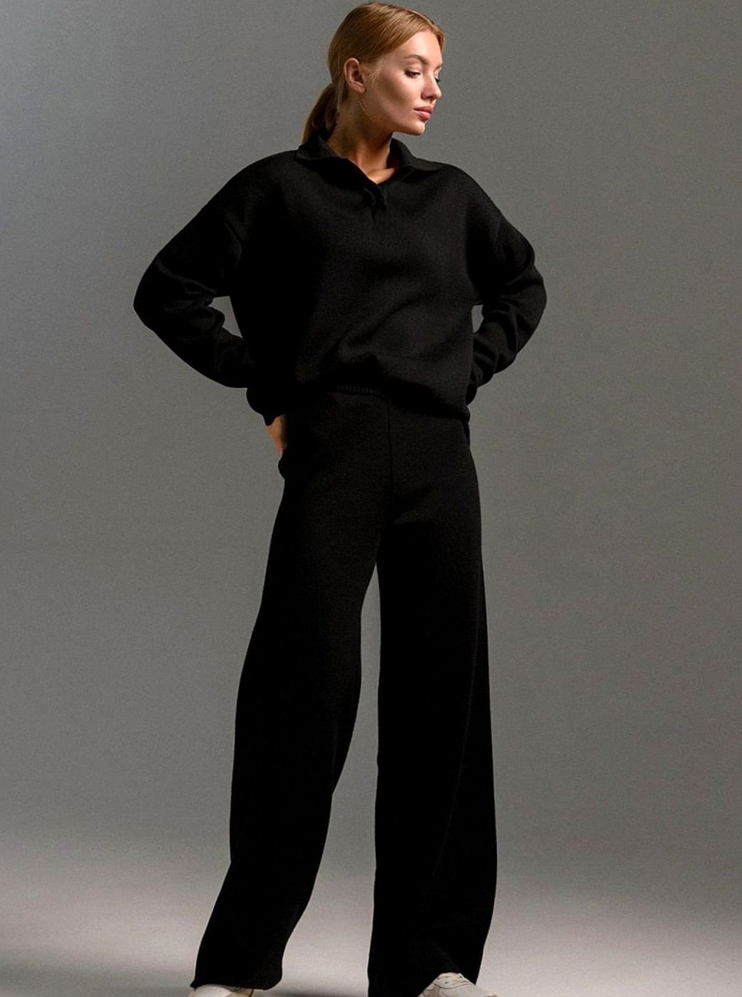 Black knit lounge set with a collared pullover and wide leg trousers, full length view