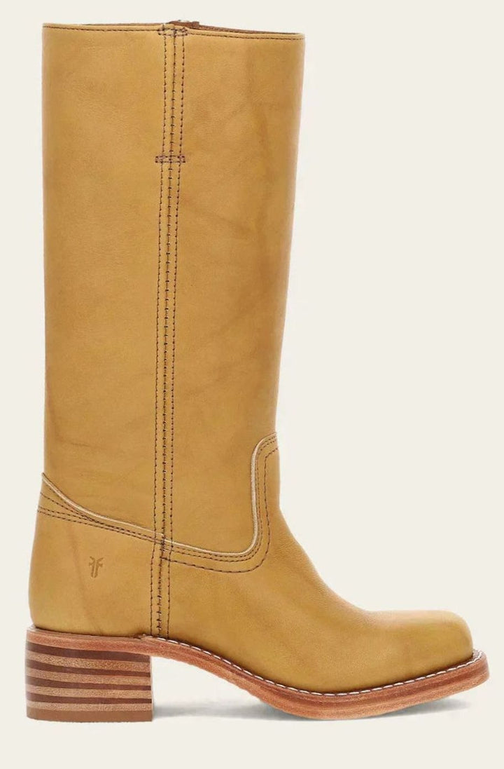 Tall tan leather pull on boot with a stacked block heel and square toe, side view on cream