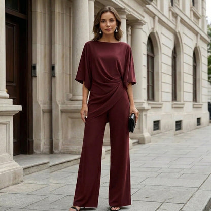 Burgundy draped cape sleeve set on a city street